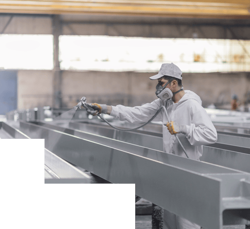 worker applying paint to metal beams