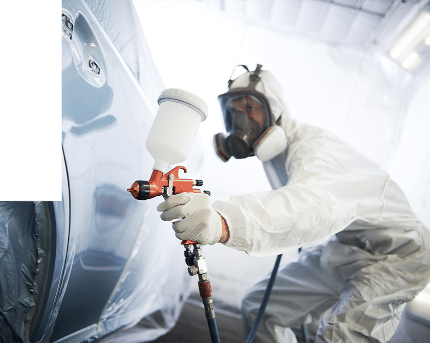 Man spraying paint on vehicle