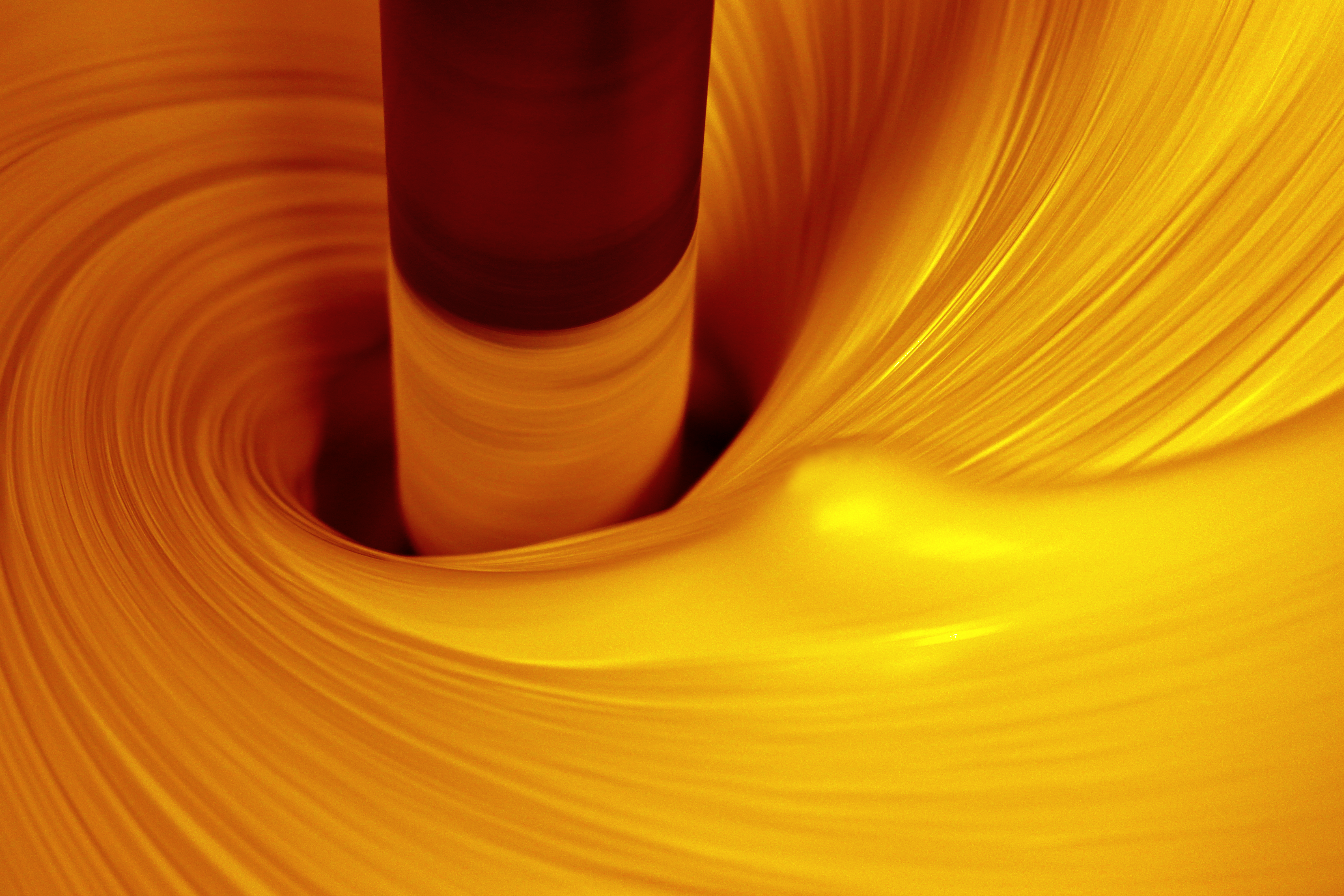 Swirl of orange paint being mixed