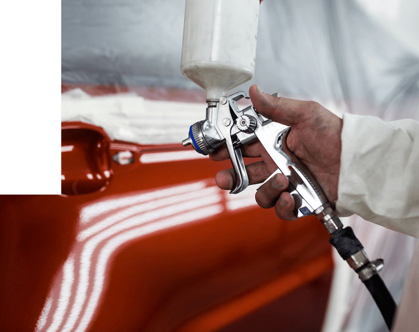applying red paint to vehicle