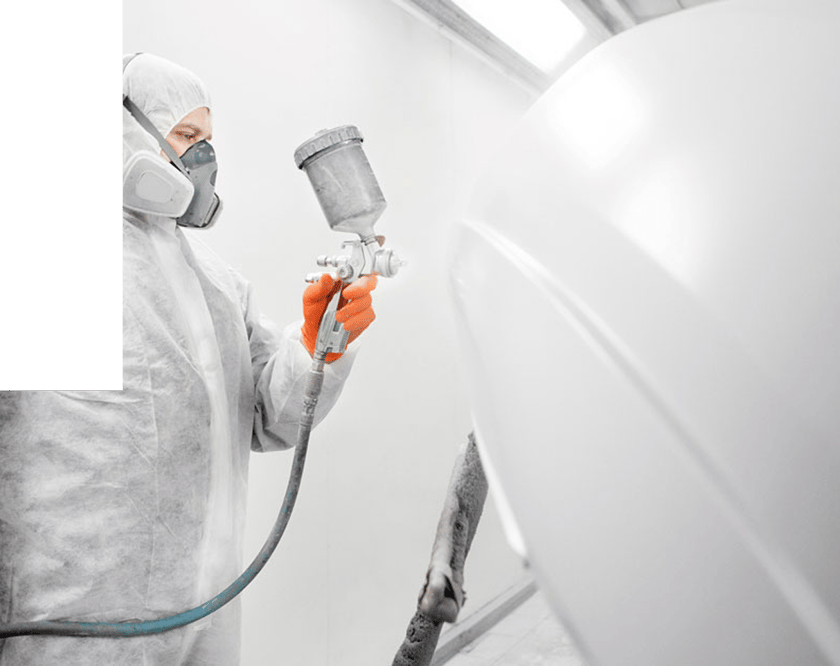 man-applying-white-paint-with-paint-applicator