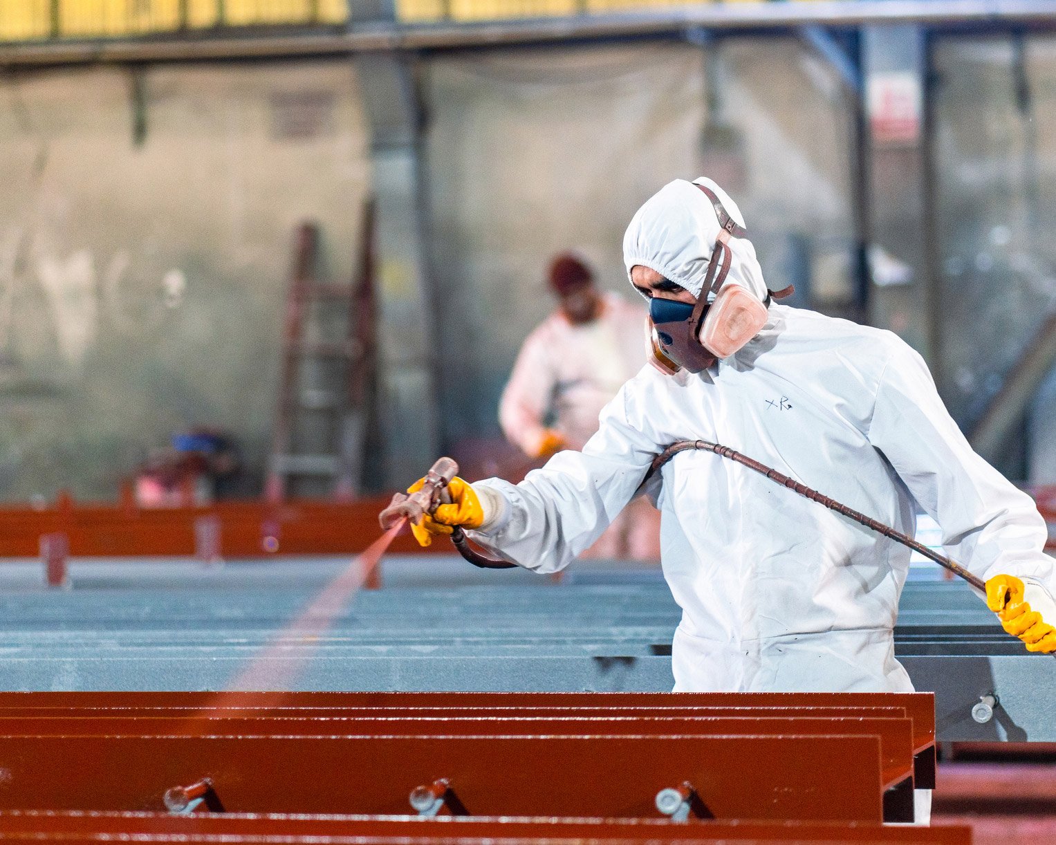 man-painting-metal-in-red-color-1
