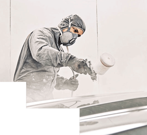 worker applying coating with gun