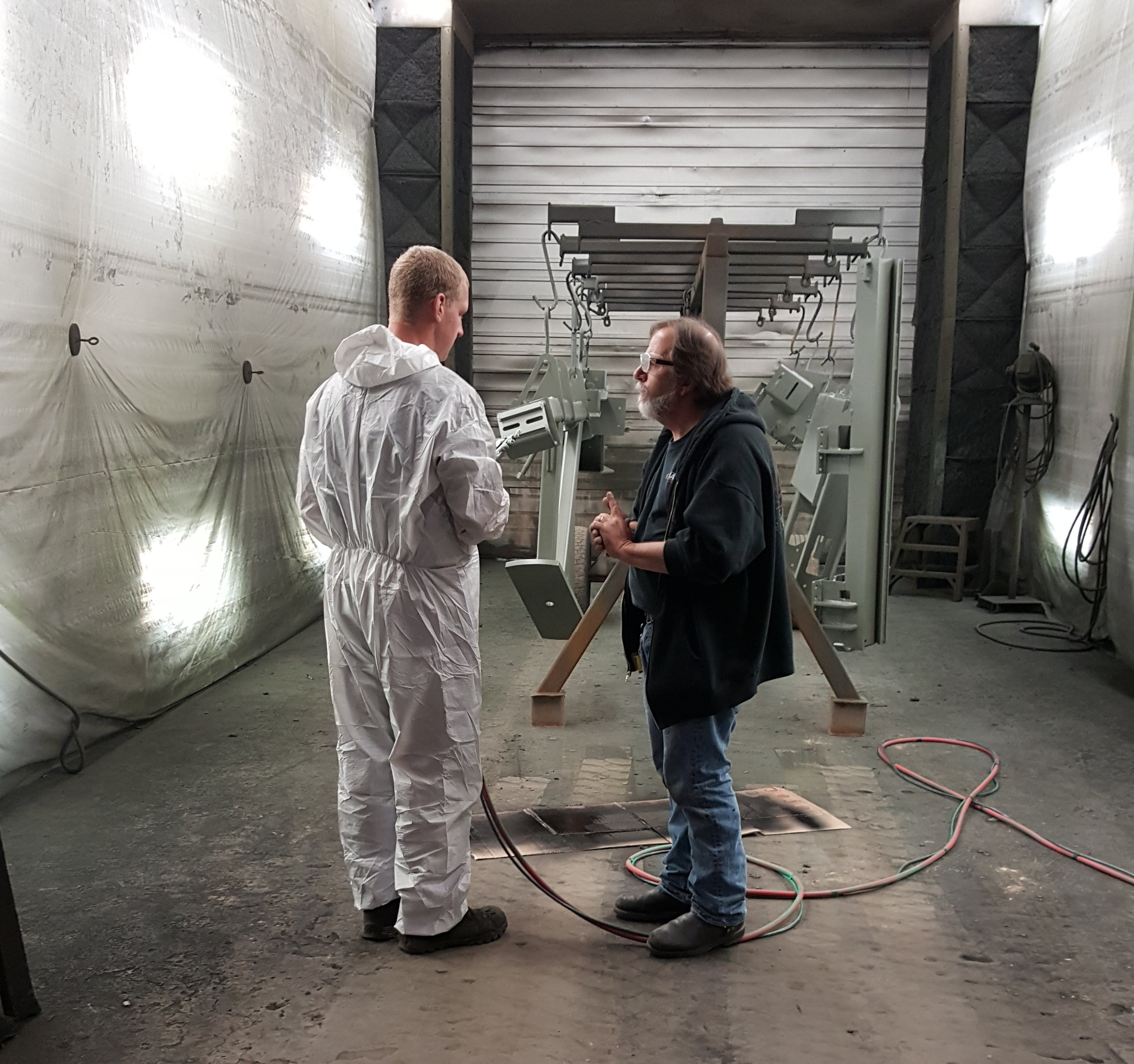 Image of Baril Coatings USA Application Expert and Engineer discussing improved throughput goals 
